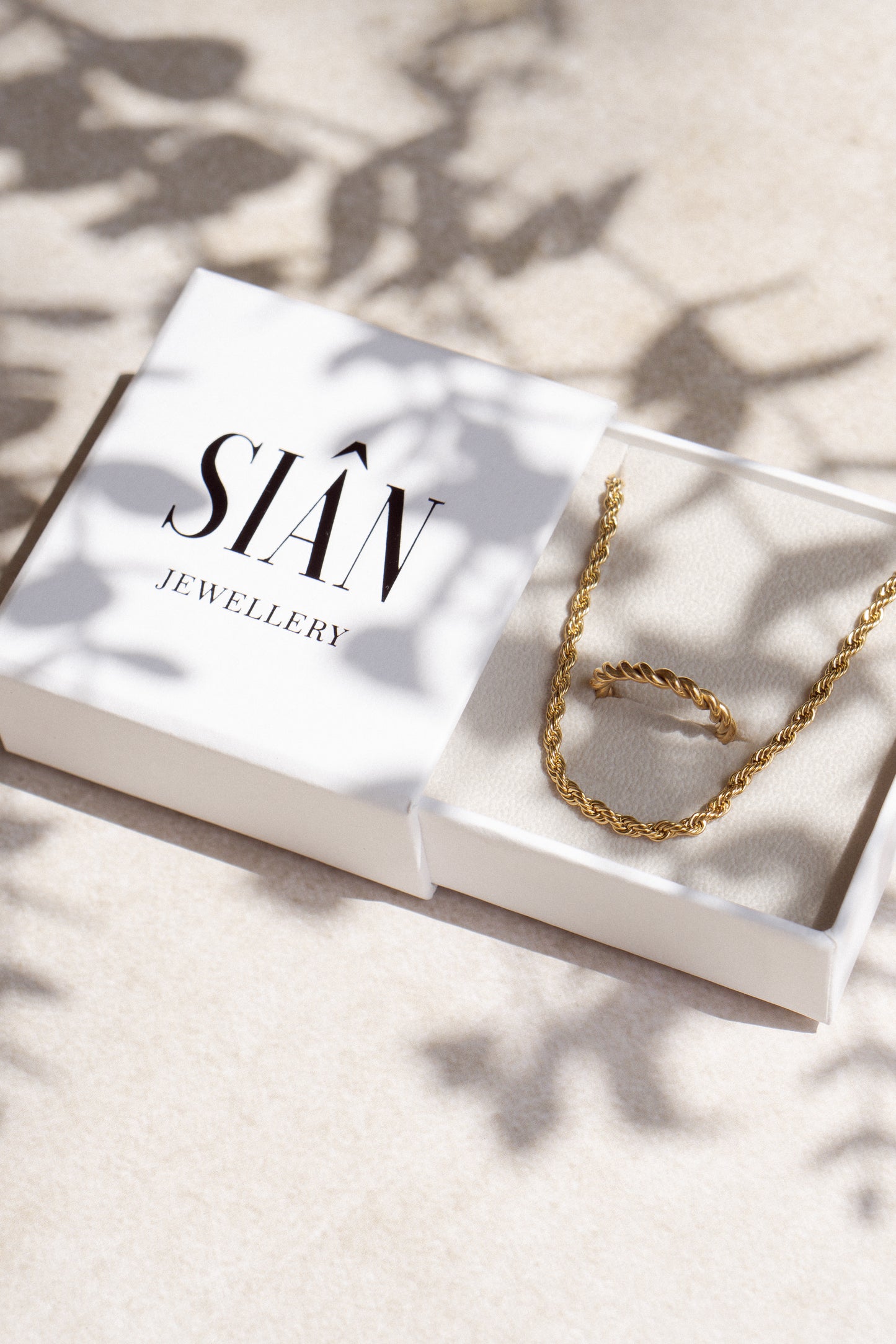 Gold plated rope chain and gold twisted ring gift set.