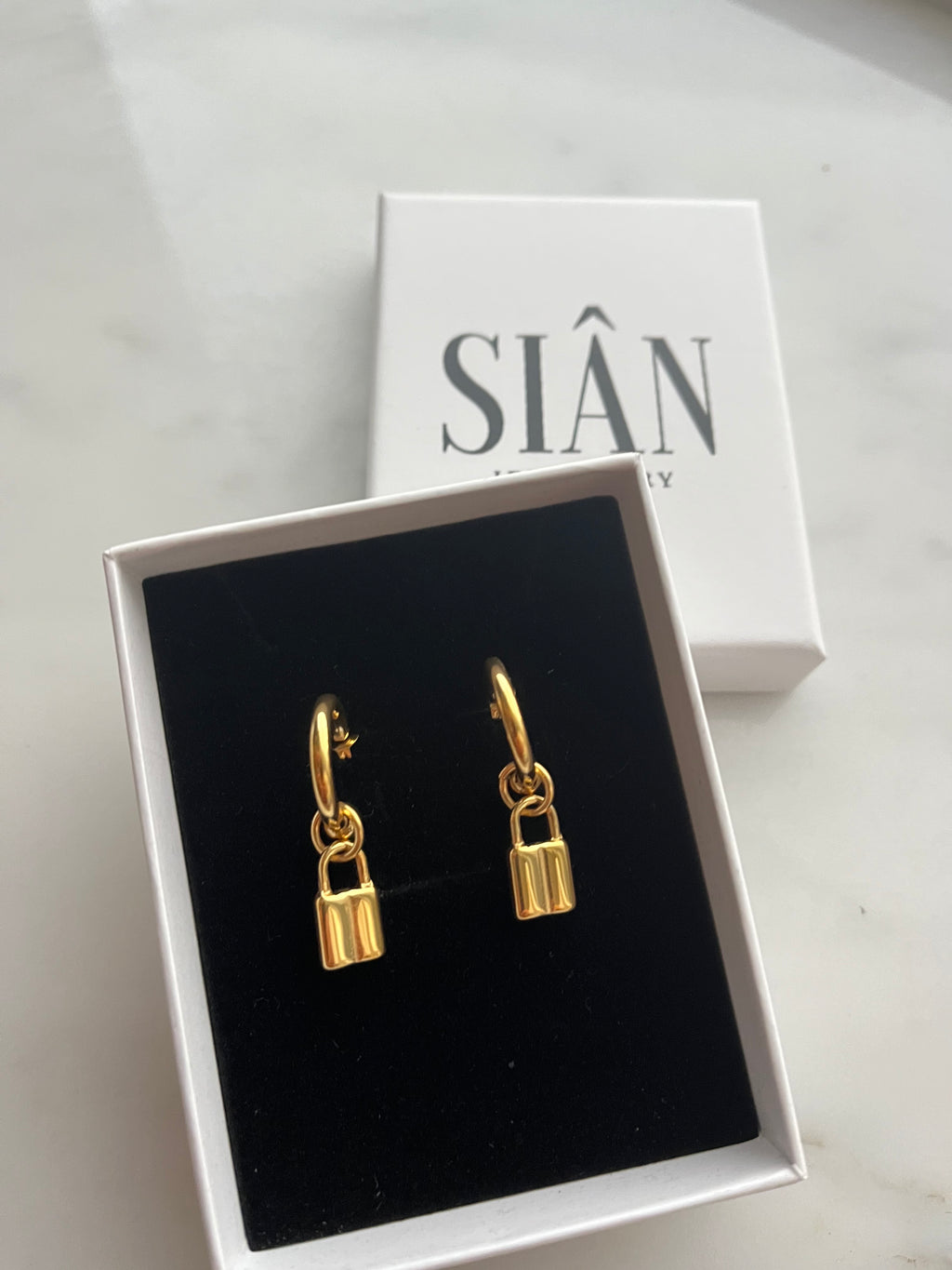 Paris Padlock Huggie Hoops, gold padlock huggie earrings, view 3